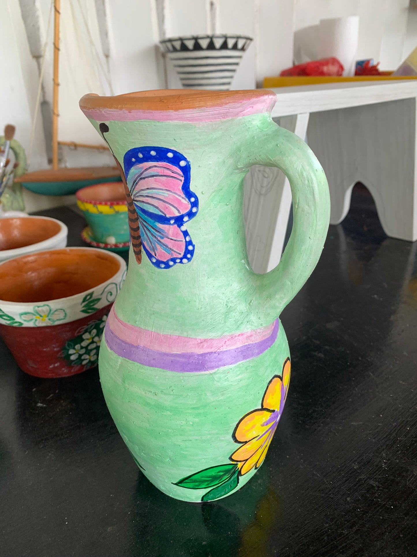 Handpainted terra cotta jug
